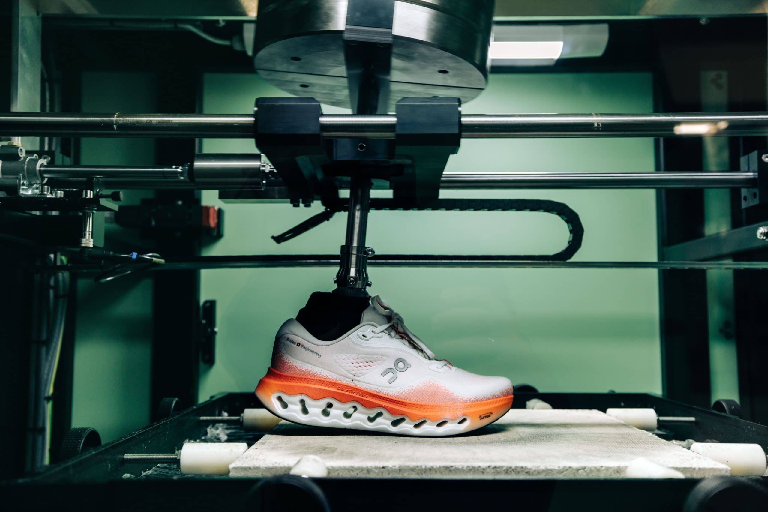 A wear-testing machine holding a running shoe in On's QA lab