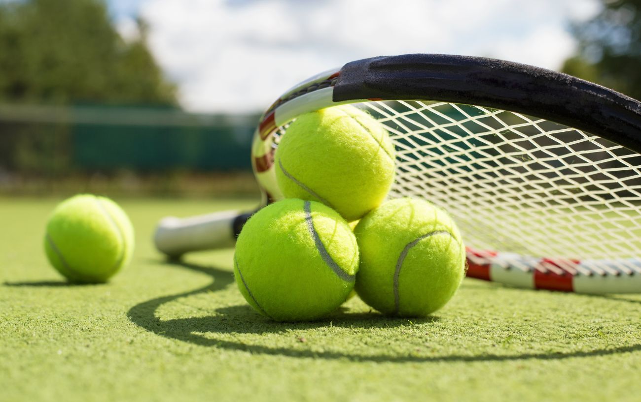 Tennis balls and a racket.