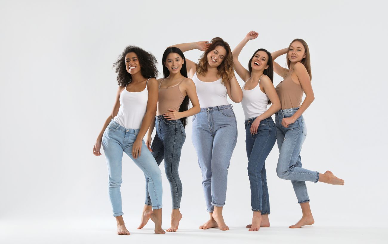 Five women with different body types posing together.