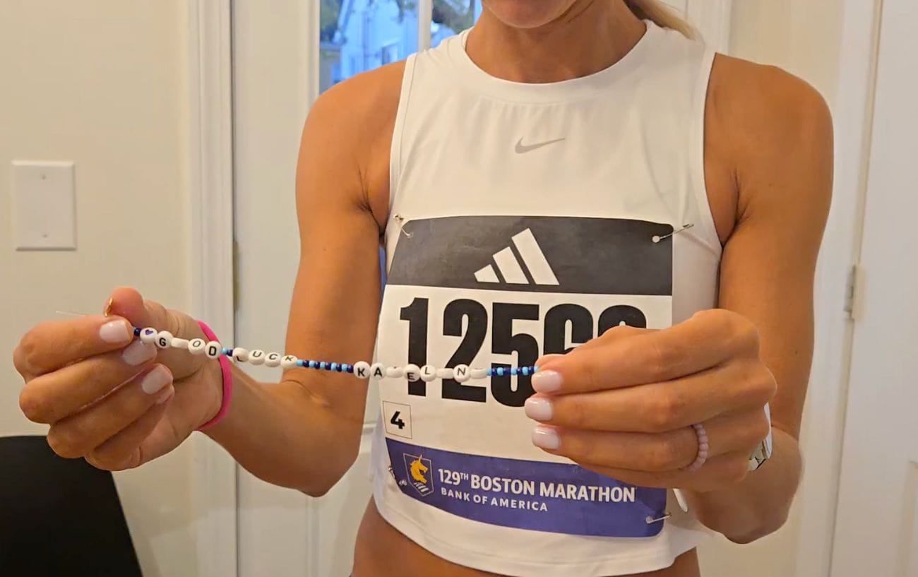 a woman holding a beaded necklace