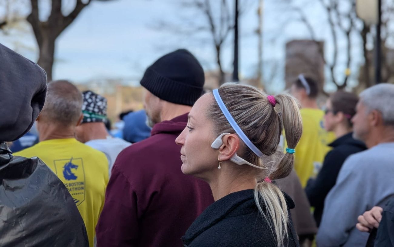 a woman with a ponytail wearing a headband and a white headband