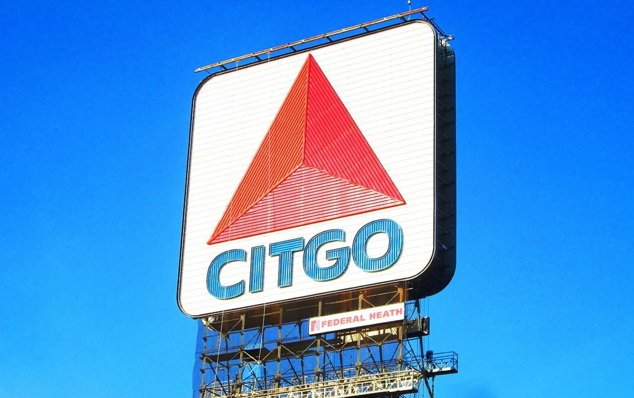 a large sign with a red triangle and blue text
