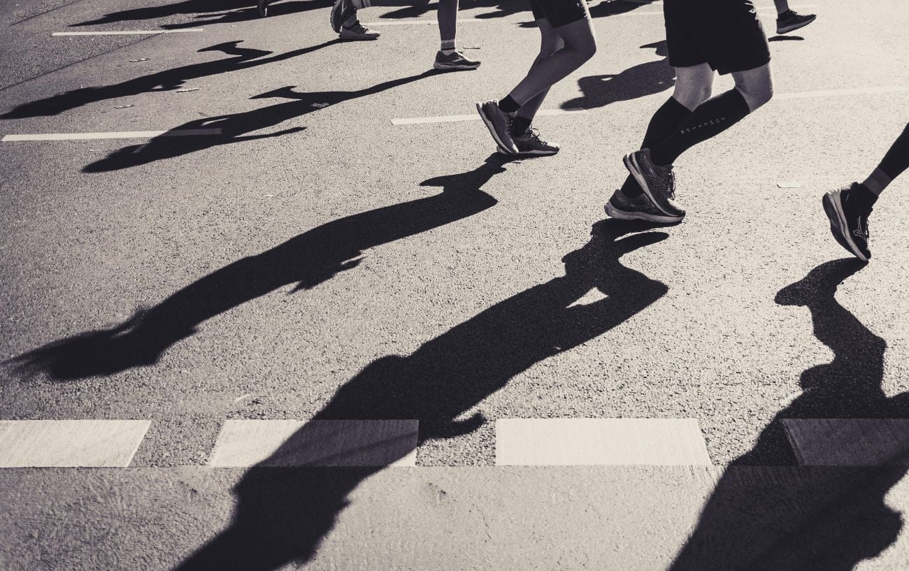 Can I Run a Half Marathon? Here’s How to Know If You’re Ready 3 a group of people running on a street