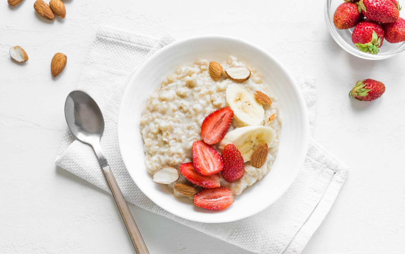 A bowl of oatmeal and fruit.