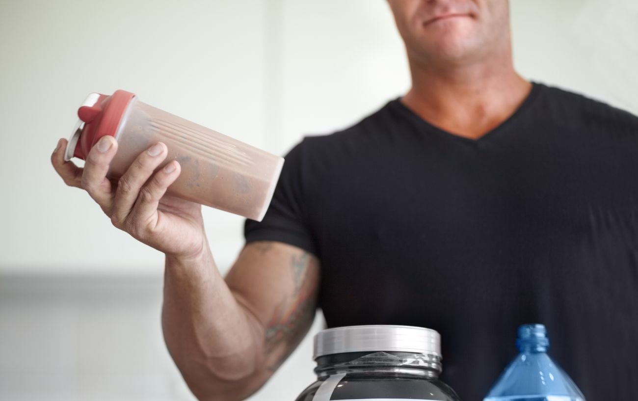 A person shaking a protein shake.