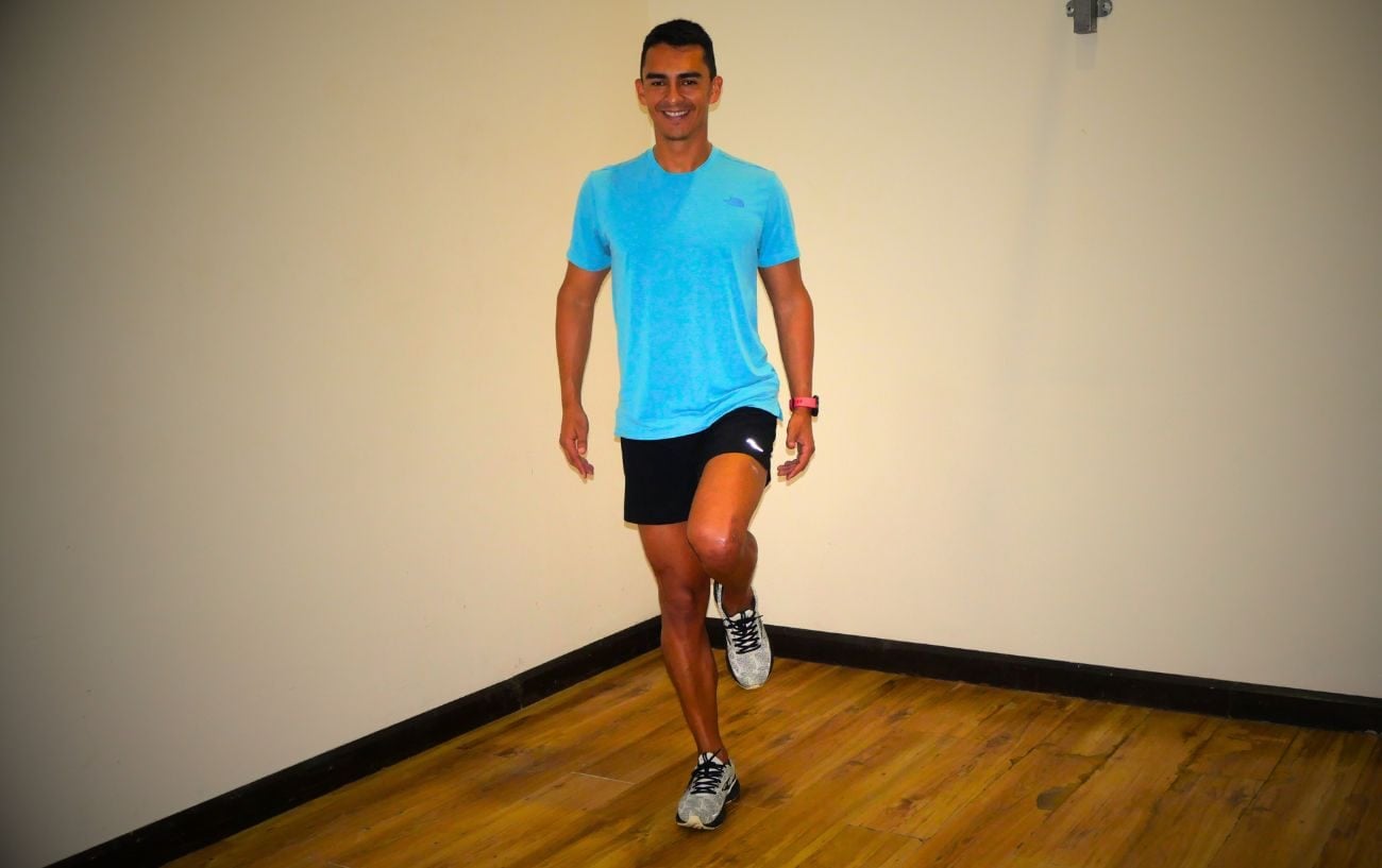 a man in a blue shirt and shorts