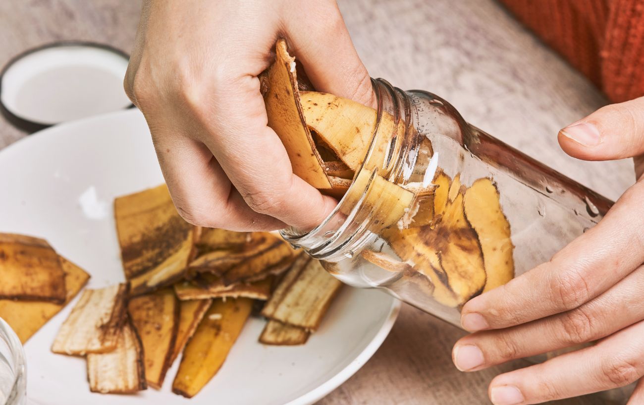 Someone taking banana peels from a jar.