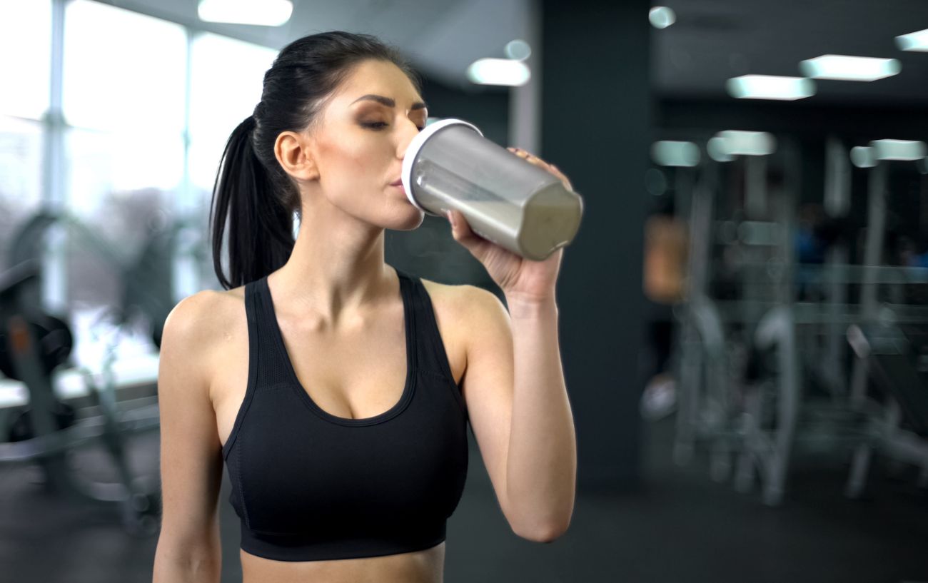 A person drinking a protein shake.