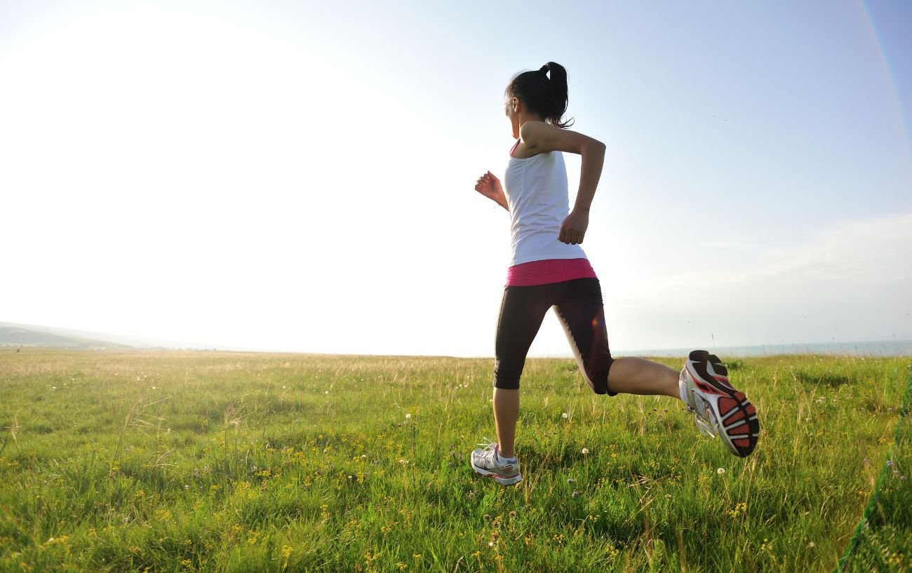 A person running in grass.