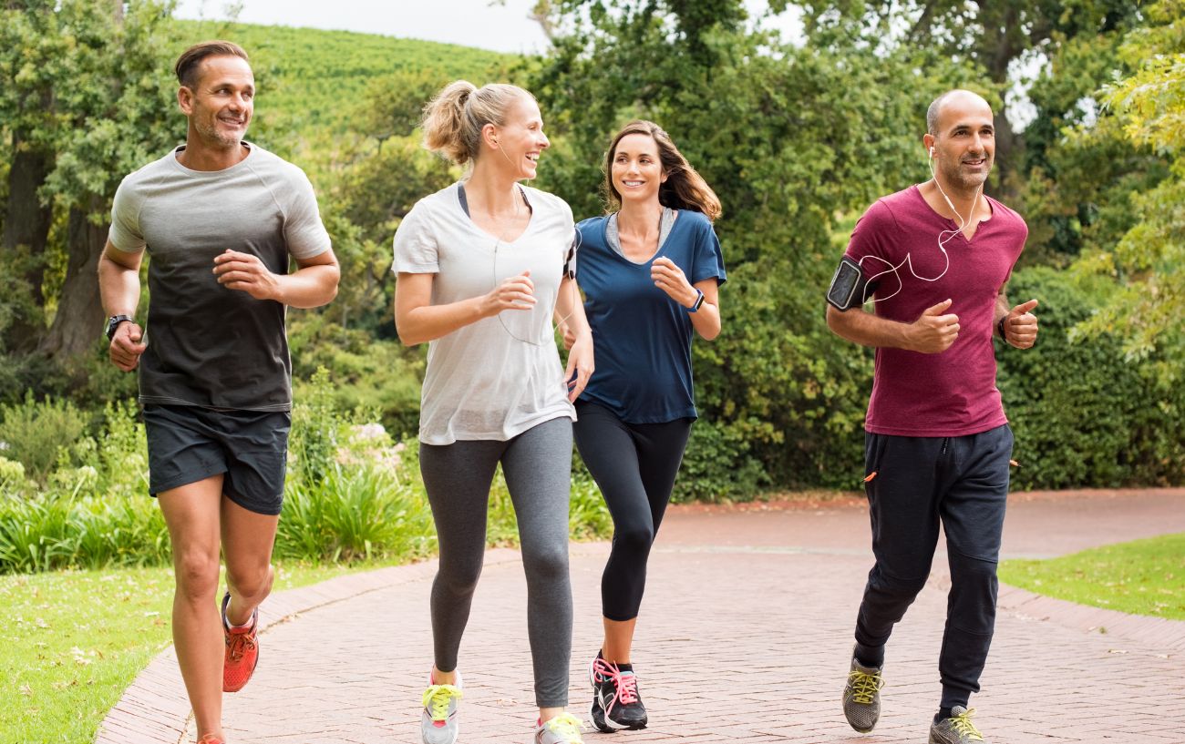 How To Run Longer Without Stopping 8 A group of people jogging together on a path.