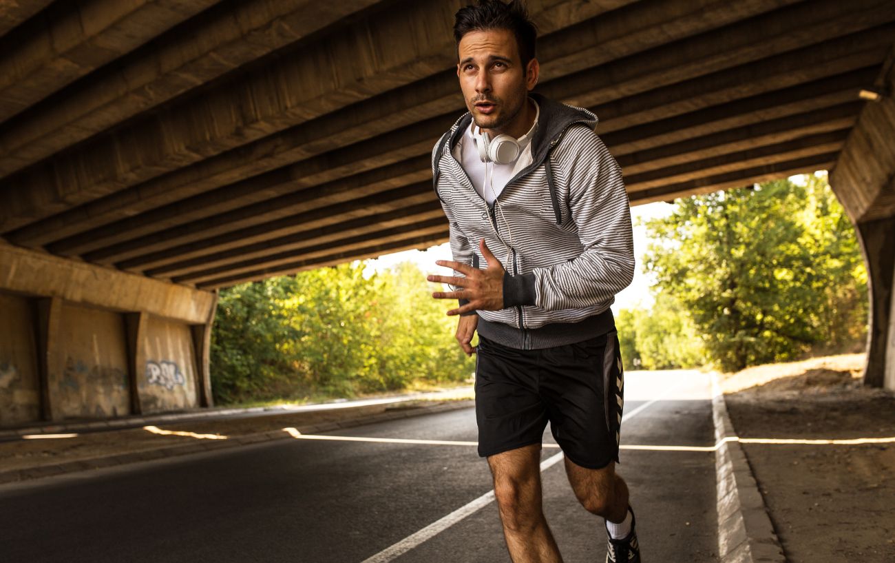 How To Run Longer Without Stopping 5 A person running under a bridge.