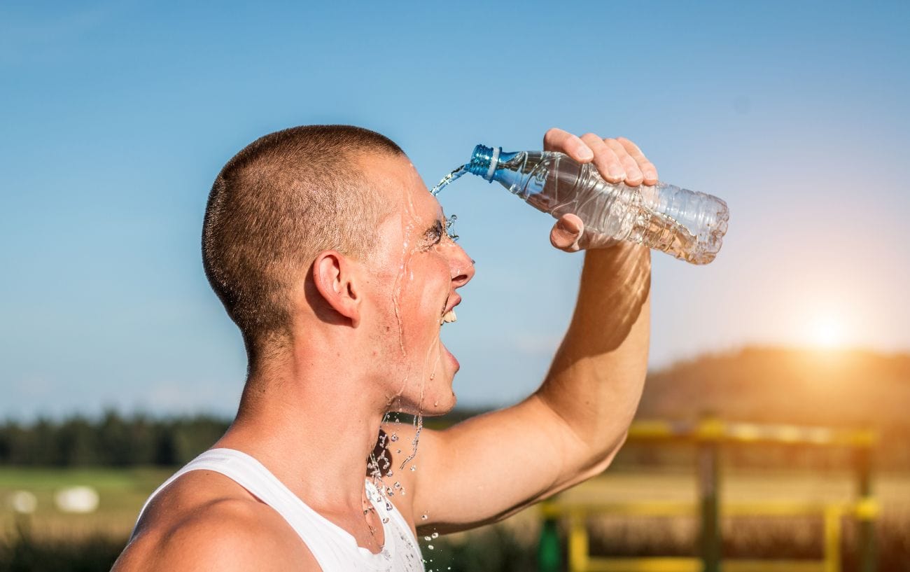 How Western States Runners Will Beat the Heat: 11 Science-Backed Cooling Strategies 3 a man pouring water from a bottle into his face