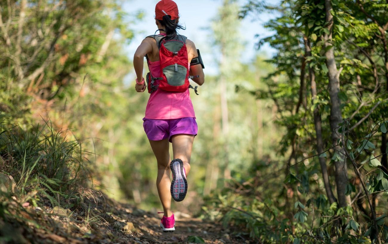 How Western States Runners Will Beat the Heat: 11 Science-Backed Cooling Strategies 6 a woman running on a trail