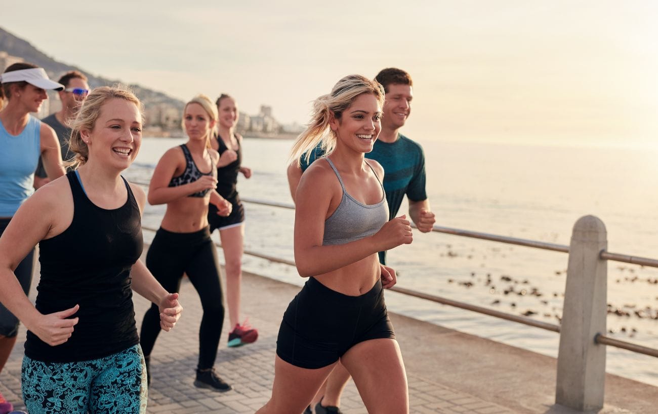 How to Build the Perfect Marathon or Half Marathon Training Plan 3 a group of people running on a dock