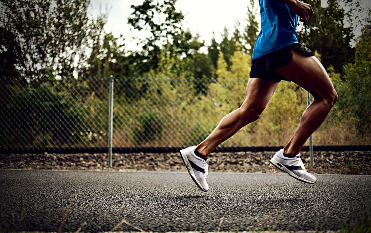 How To Improve Running Form: 29 Ways To Run More Efficiently 4 A person running on the road working on how to improve running form.