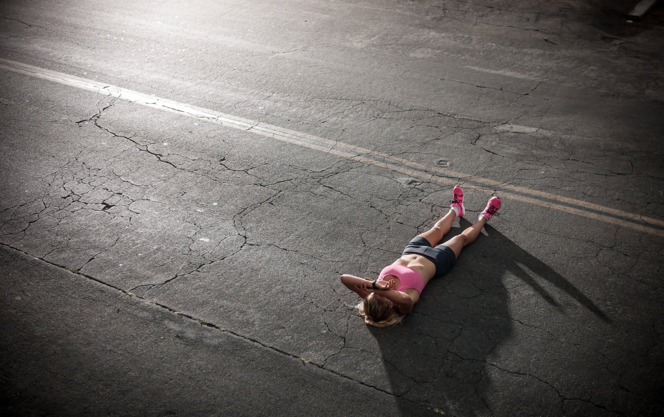 Iron Deficiency in Runners: Why It's Missed, How to Catch It, and What to Do About It 2 A runner laying on the road.