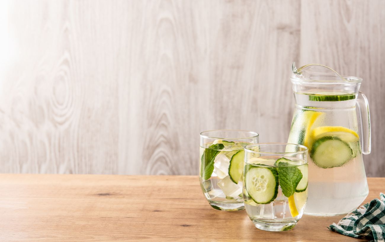 Lemon salt water in a pitcher and glasses.