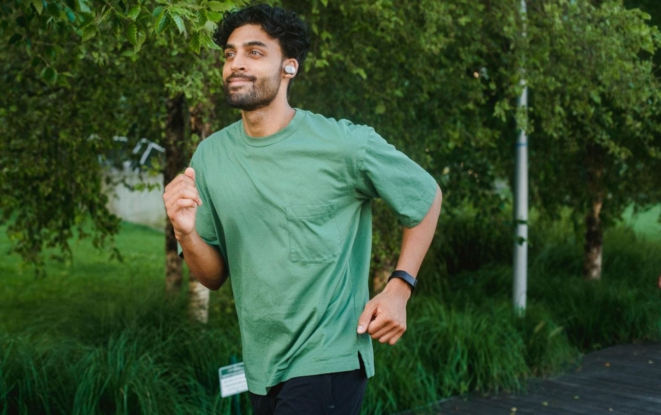 a man running outside with earbuds