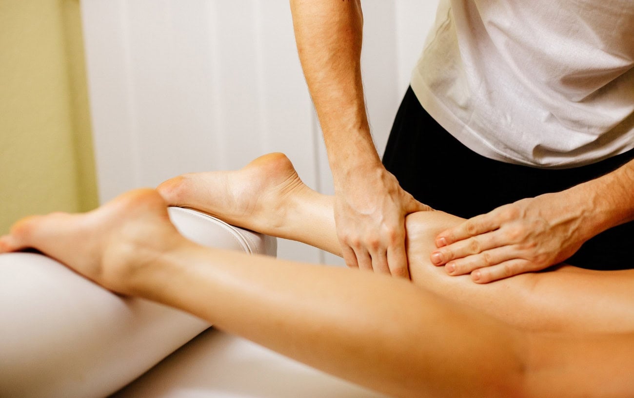 Marathon Training Recovery: How To Recover Quickly After Workouts 6 A person getting a massage