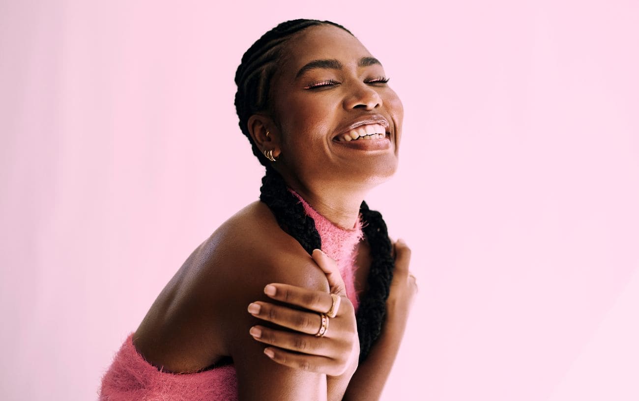 Mind Over Marathon: 5 Mental Strategies Proven To Work On Race Day 3 Person posing against pink background.