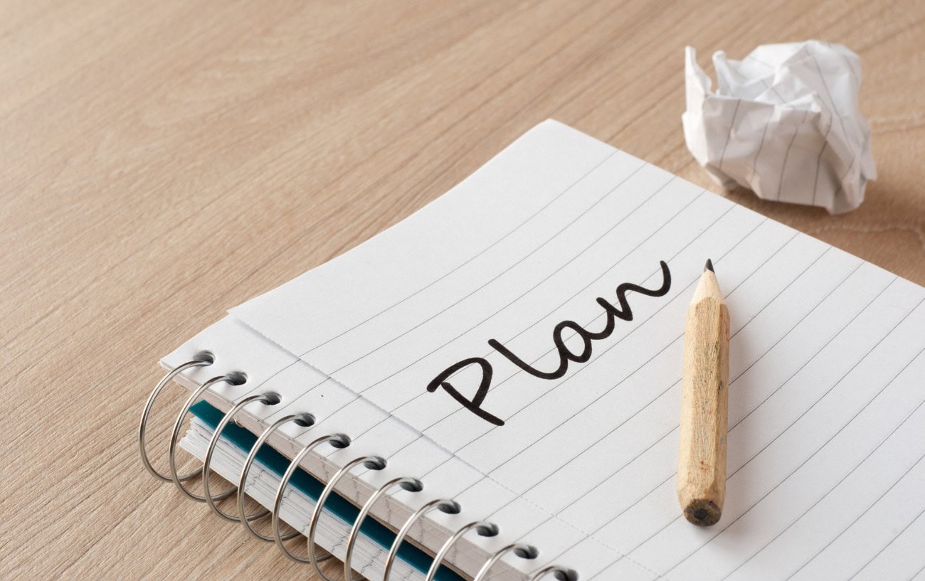 Running Motivation That Works: 11 Tips to Help You Stay on Track 7 Notebook with 'Plan' written down