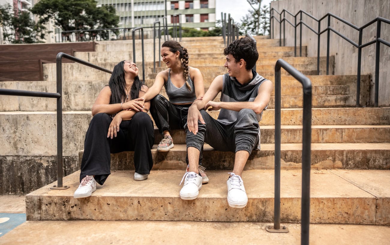 Running Motivation That Works: 11 Tips to Help You Stay on Track 2 Three friends sitting on stairs.