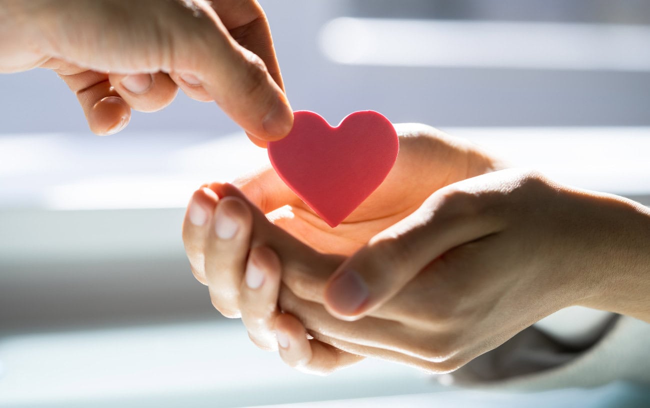 Running Motivation That Works: 11 Tips to Help You Stay on Track 4 Hands exchanging a heart symbol