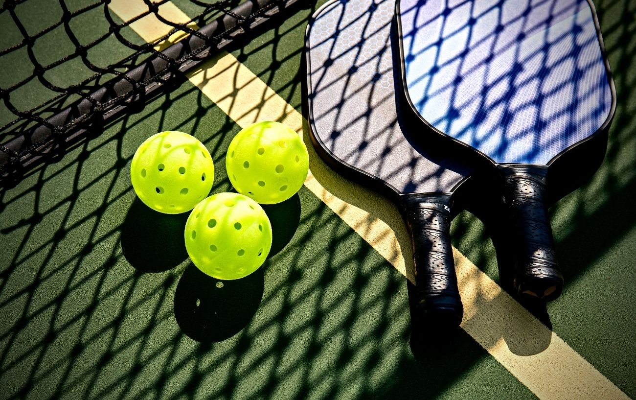 Pickleball balls, rackets and net.