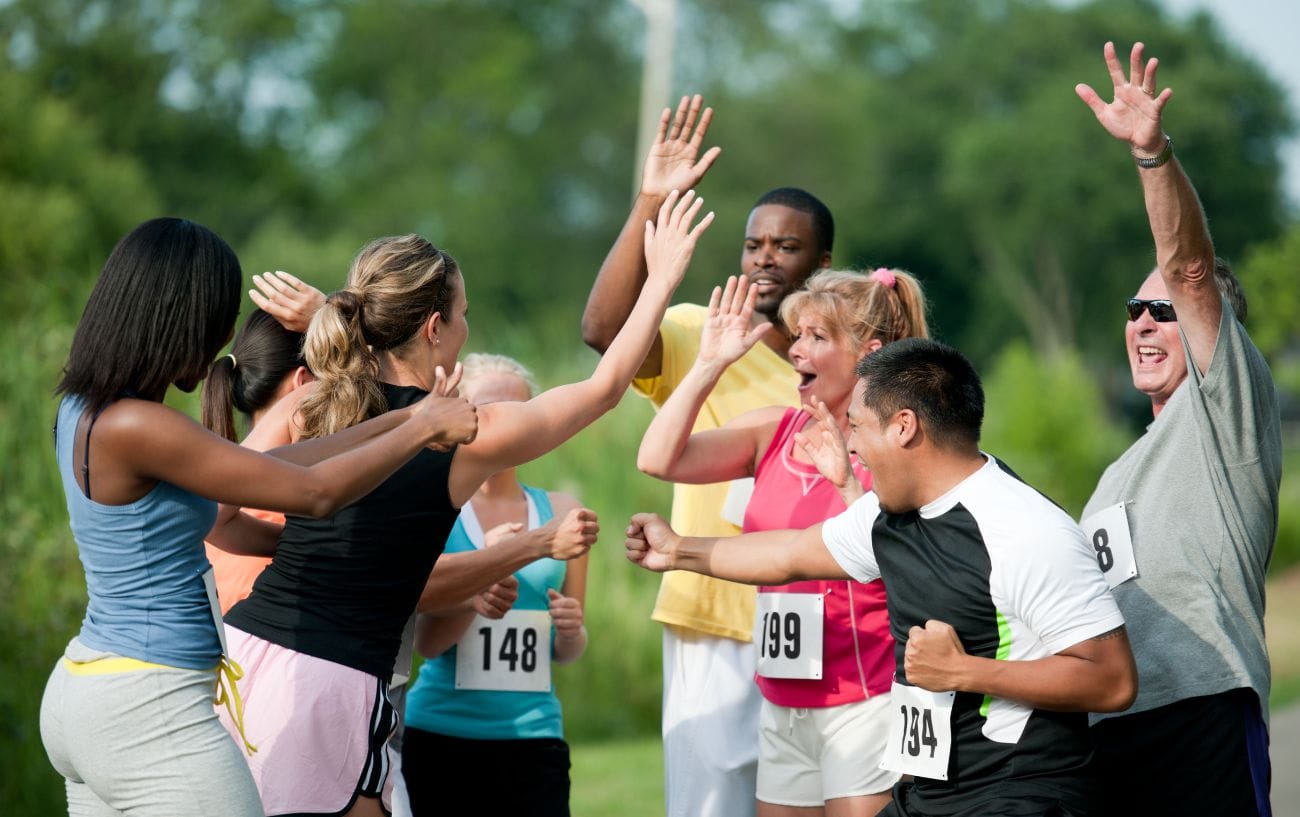 Beyond the Finish Line: Understanding and Overcoming the Post-Marathon Blues 3 a group of people celebrating a marathon