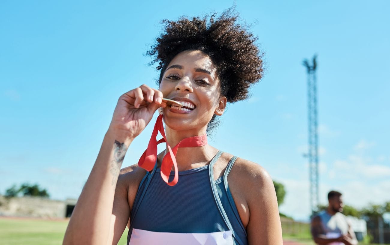 Beyond the Finish Line: Understanding and Overcoming the Post-Marathon Blues 2 a woman with a medal around her neck