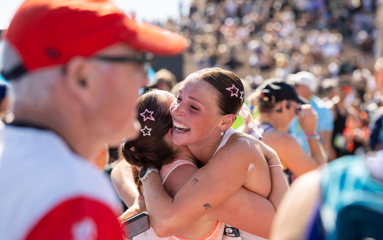 Two people hugging after the marathon.
