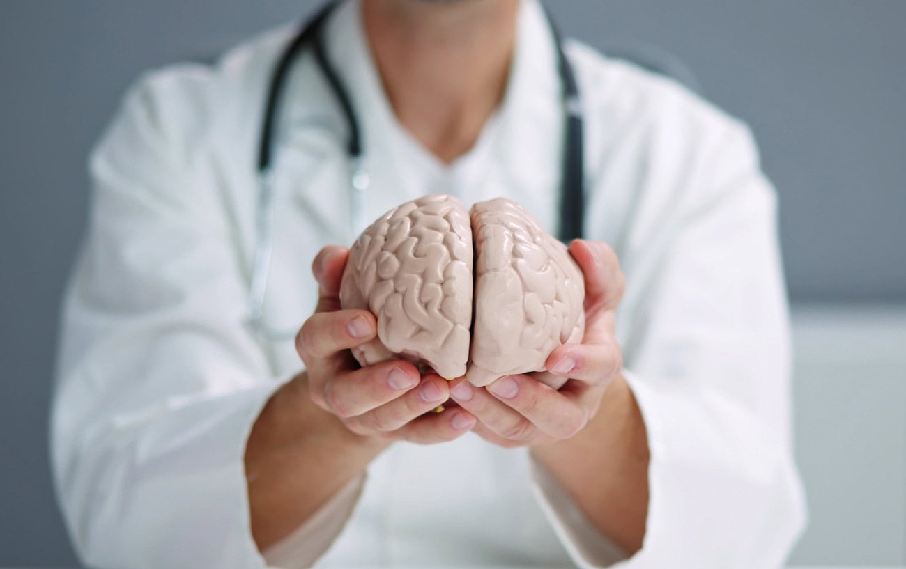 Does Brain Stimulation Boost Endurance? 1 A doctor holding a brain.
