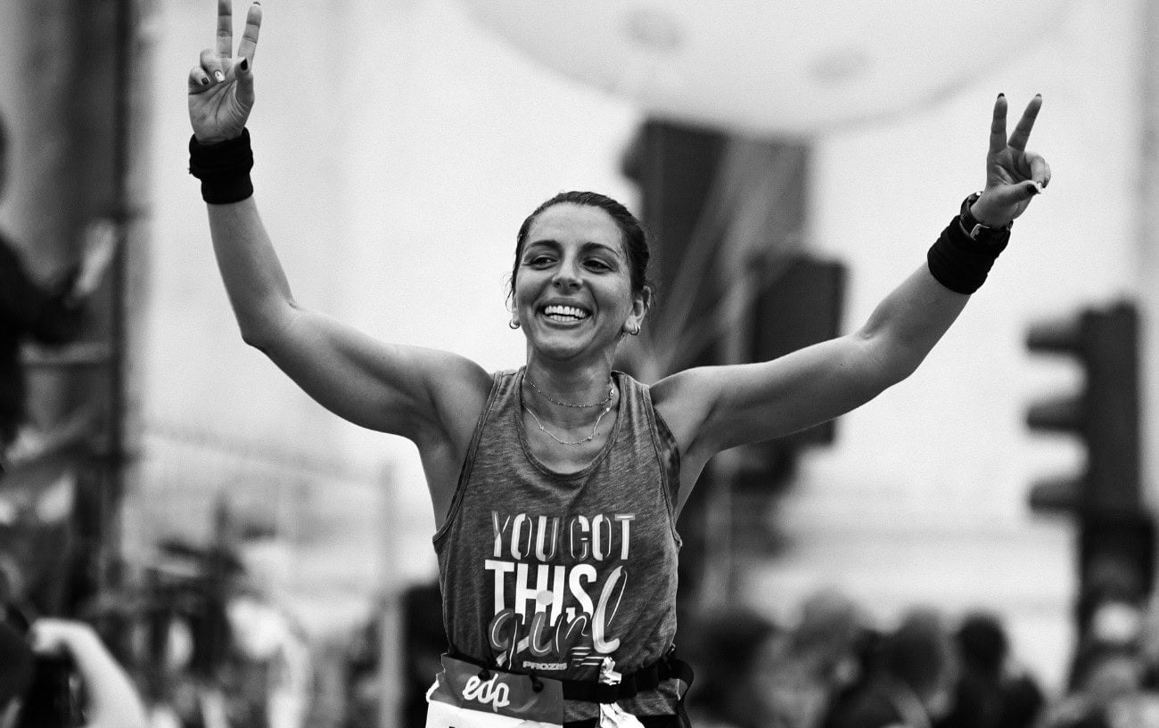 How To Fall Back In Love With Running: Intrinsic Motivation And Smarter Goals 2 A runner in a race smiling