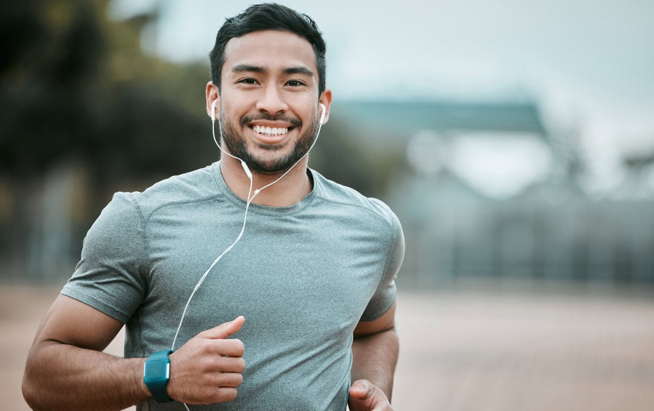 How To Fall Back In Love With Running: Intrinsic Motivation And Smarter Goals 3 A runner smiling at the camera
