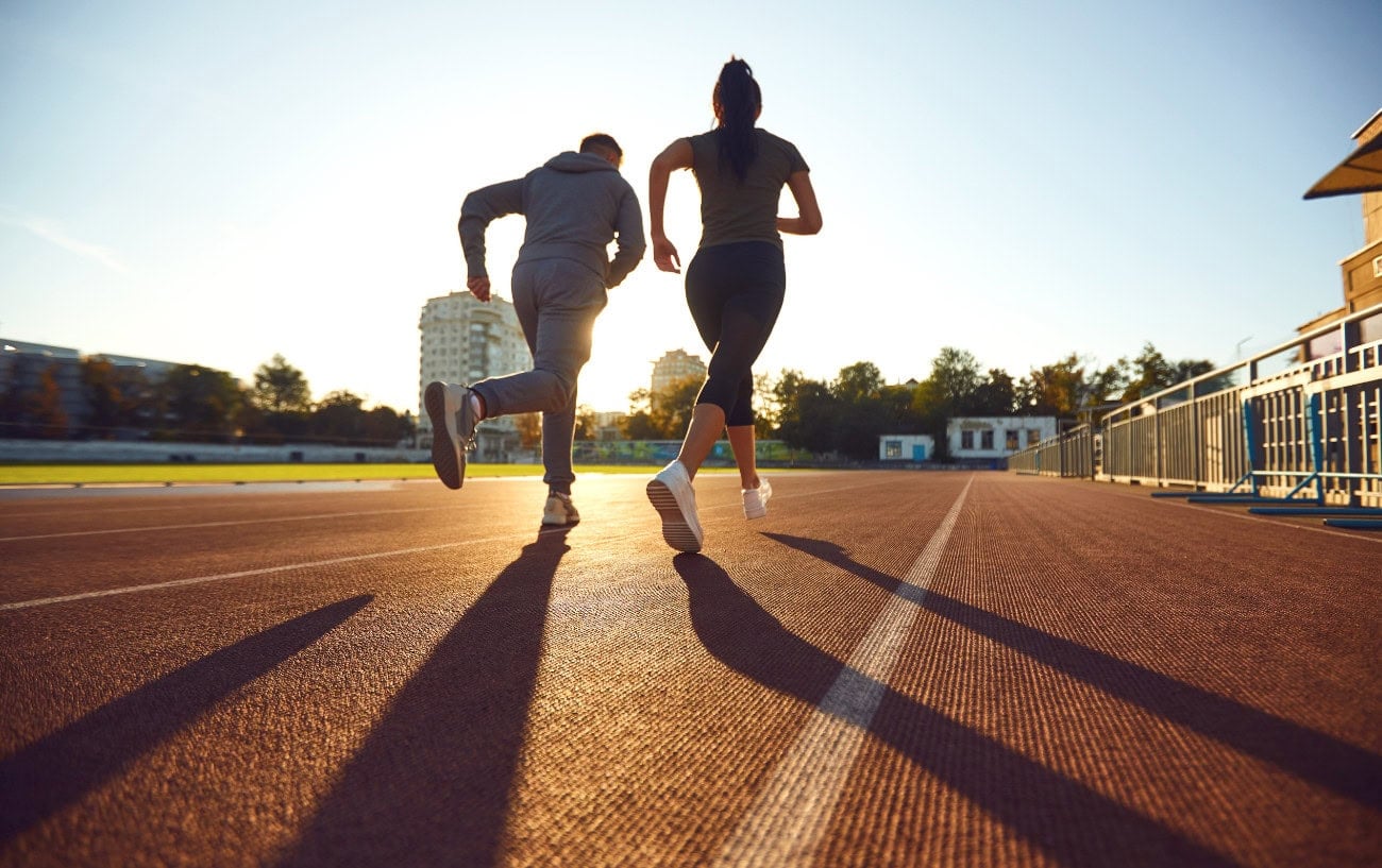 Running A Marathon Isn't Meant To Be Easy 2 Two people running on a track.