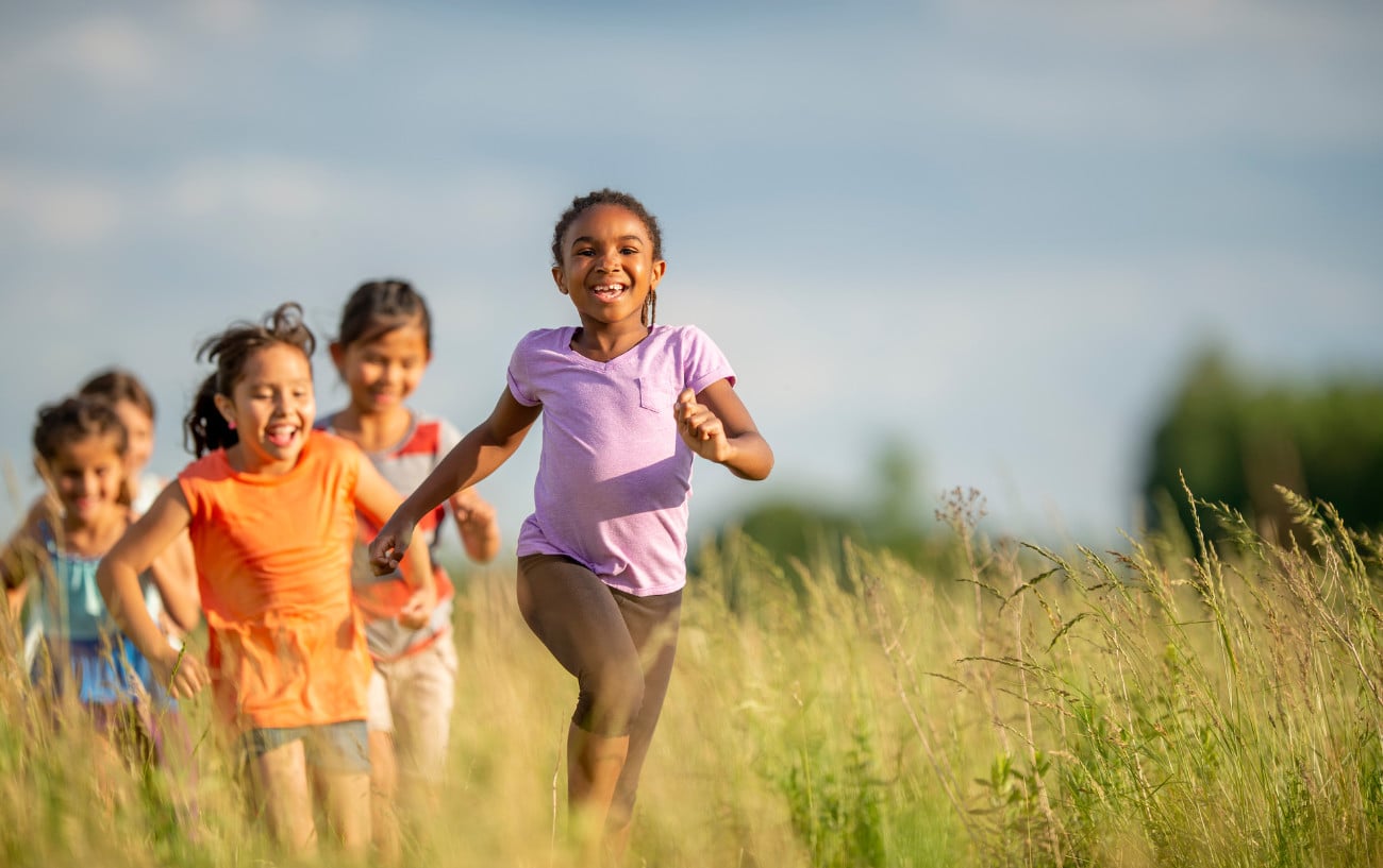 Children running in a field. 