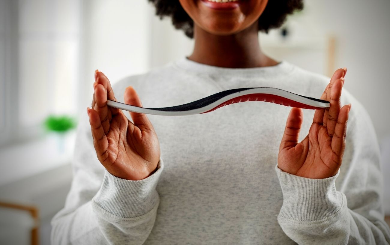 Running In Orthotics: What Does The Science Actually Say? 1 A person holding an insole.