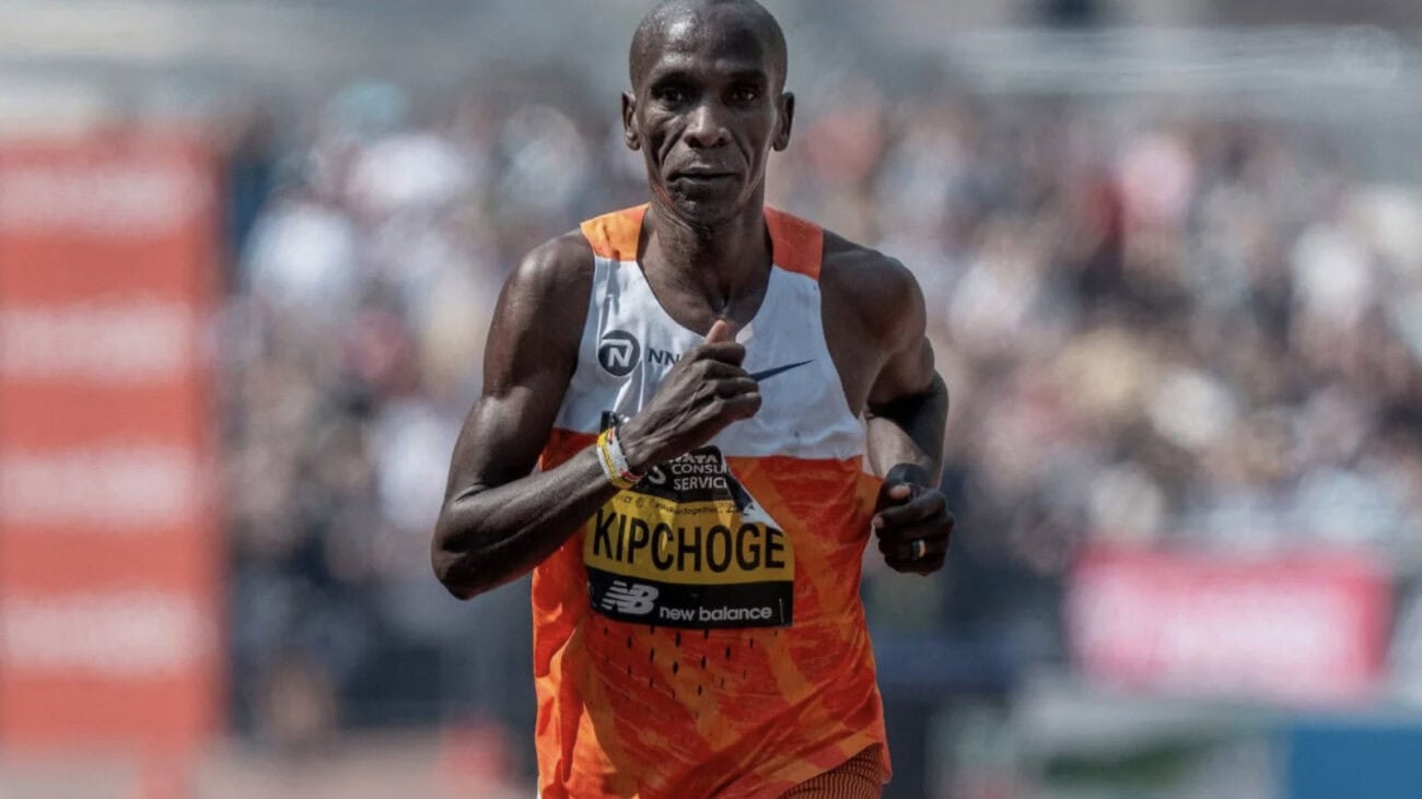 Runner in bright orange jersey sprinting.