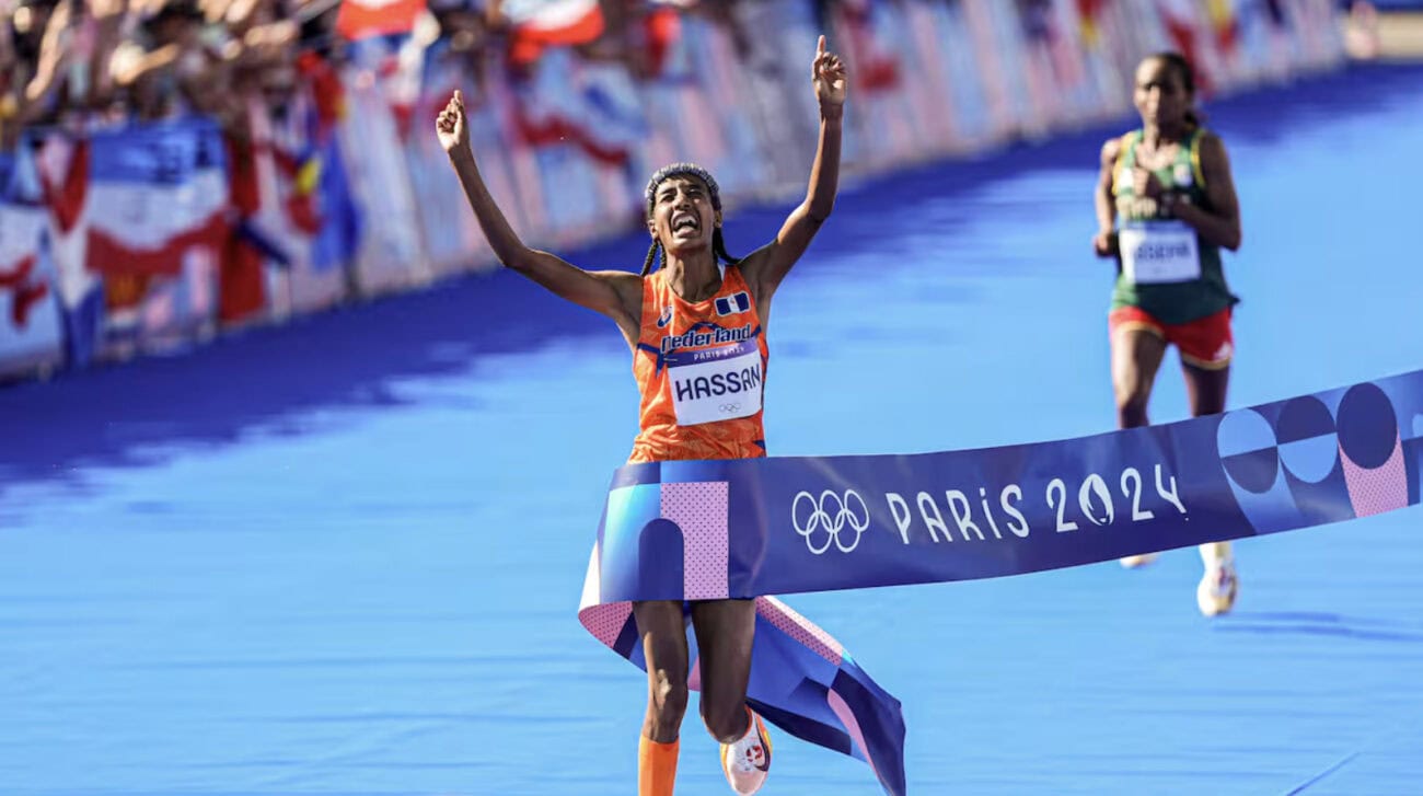 Athlete celebrating victory at finish line.