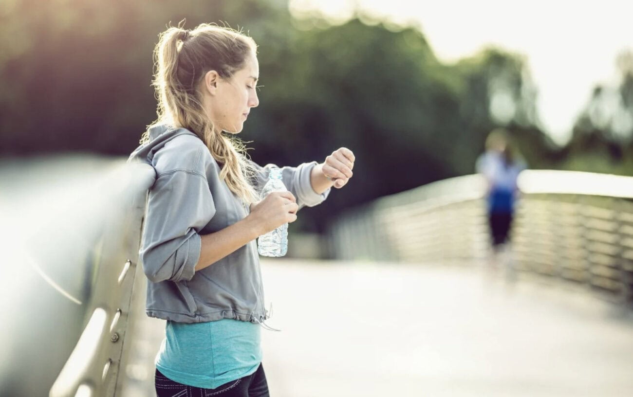Why Runners Have Extremely Low Heart Rates—Is It Training or Genetics? 1 A runner looking at her watch.