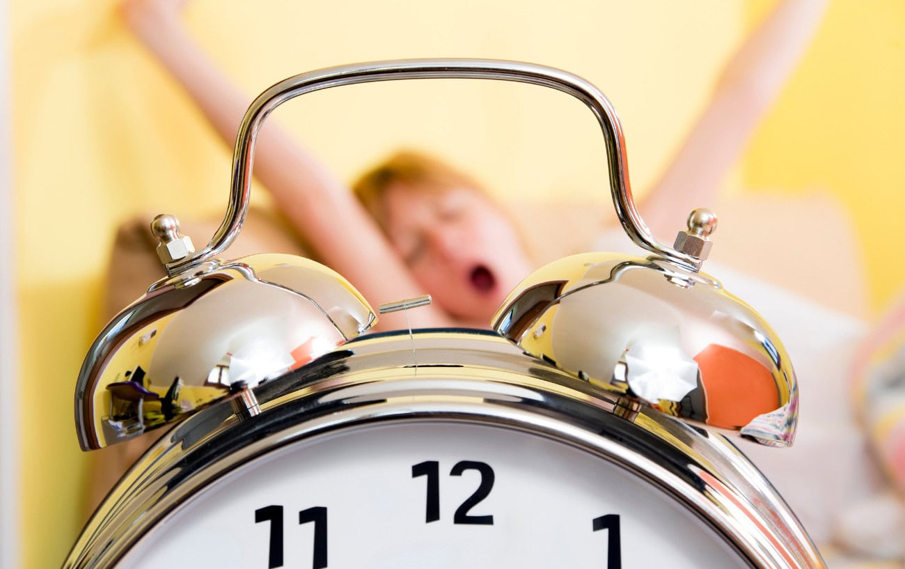 Sleep: The Essential Part of Training That Most Runners Overlook 4 a woman yawning in bed
