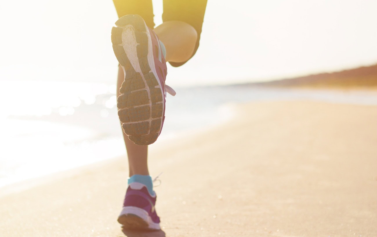 Sleep: The Essential Part of Training That Most Runners Overlook 3 a person running on a beach