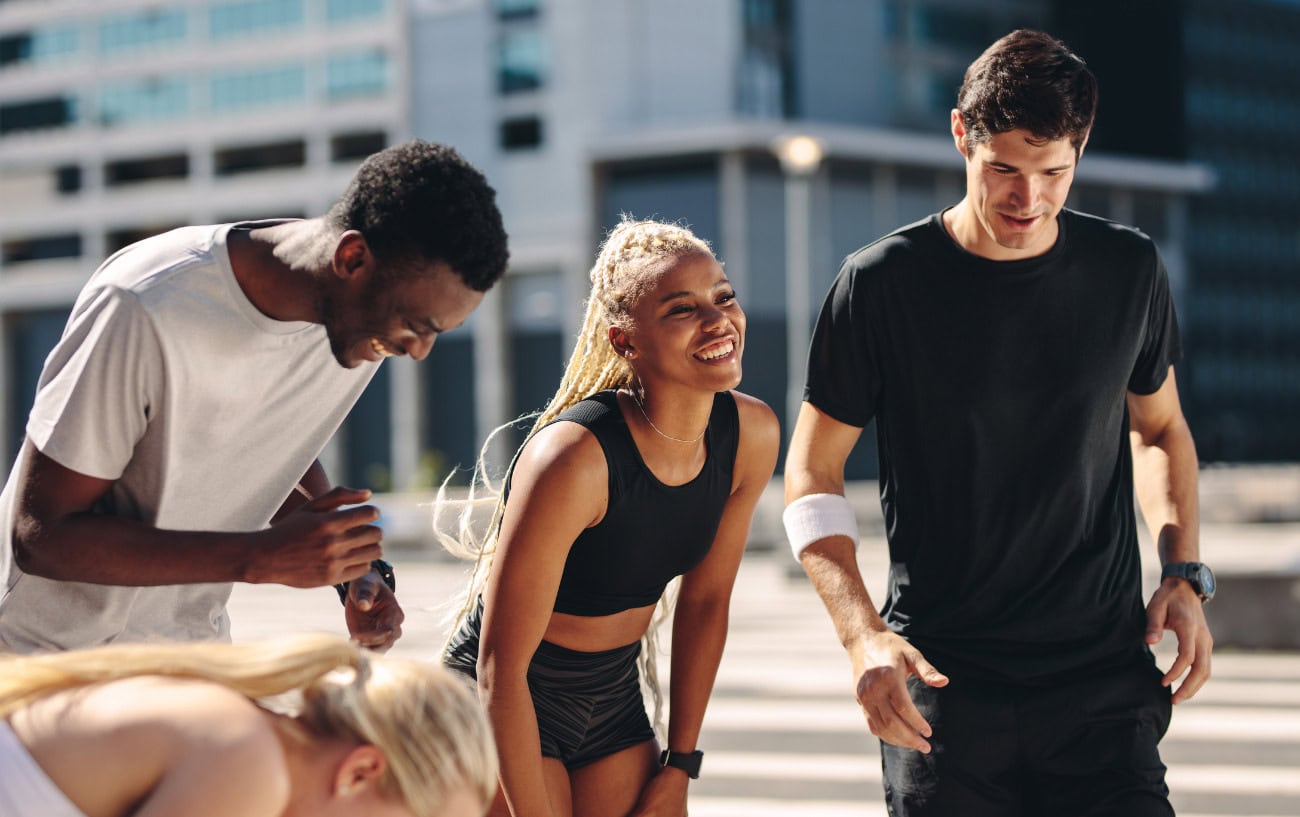 Why Running Feels So Good: The Secret Behind Runner’s Highs and Flow States 2 A group of runners smiling.