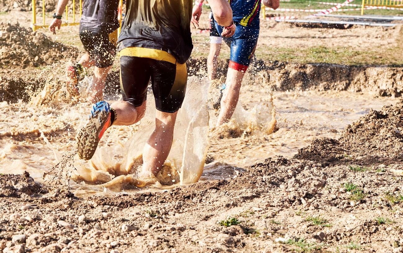 People running through mud.