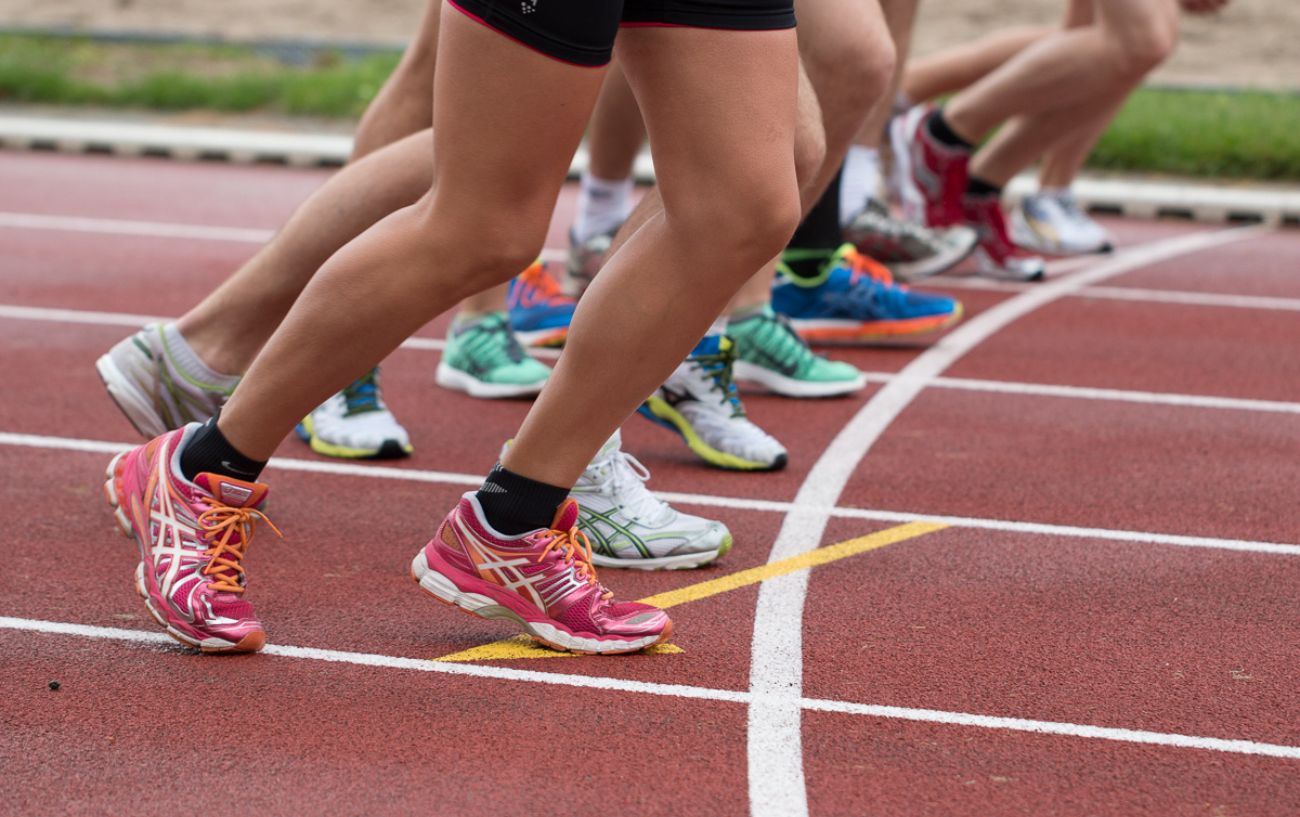 People toeing the line on a track.