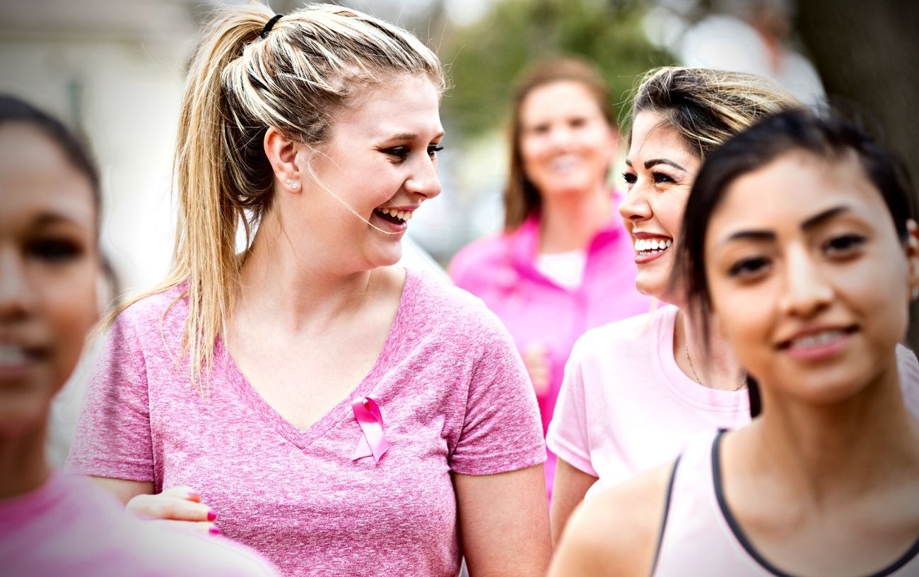 A group of people at a breast cancer charity walk.