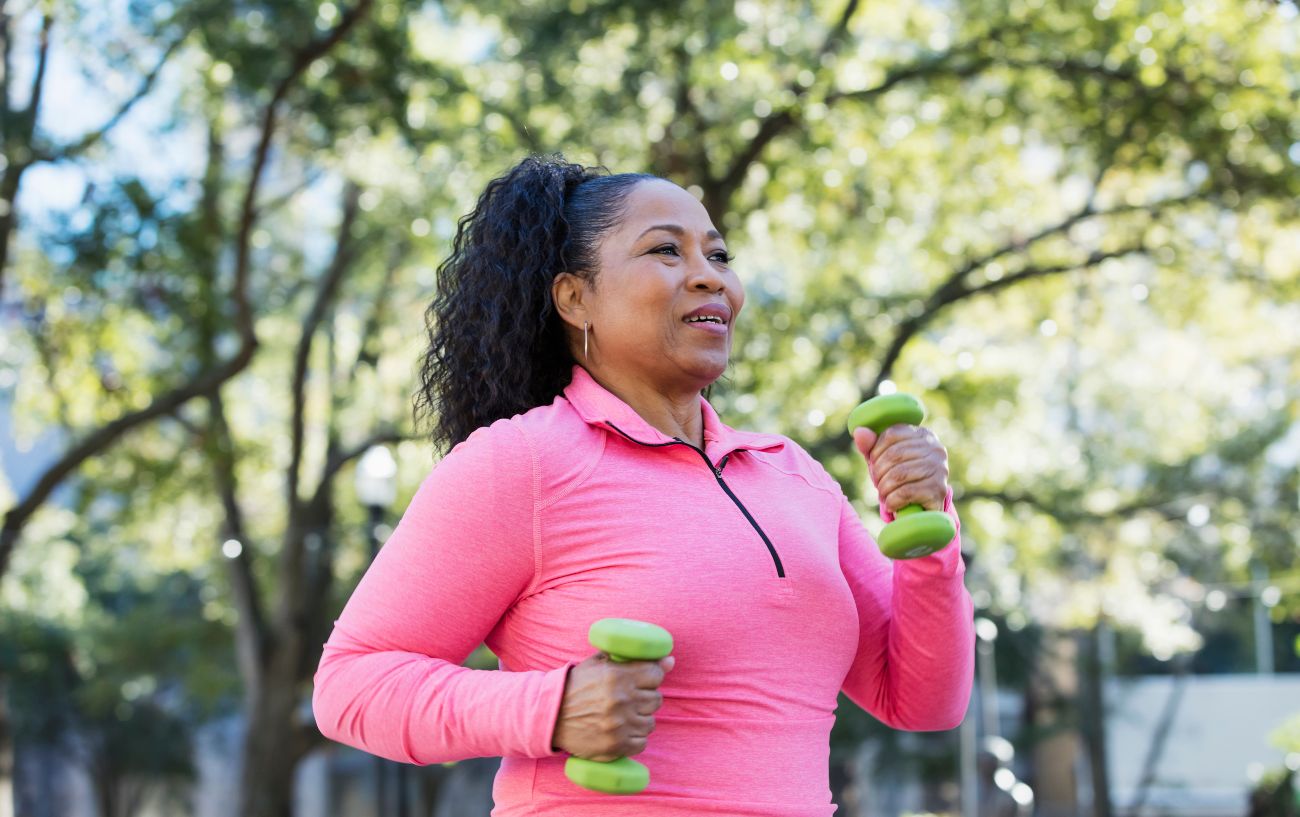 A person walking with dumbbells.