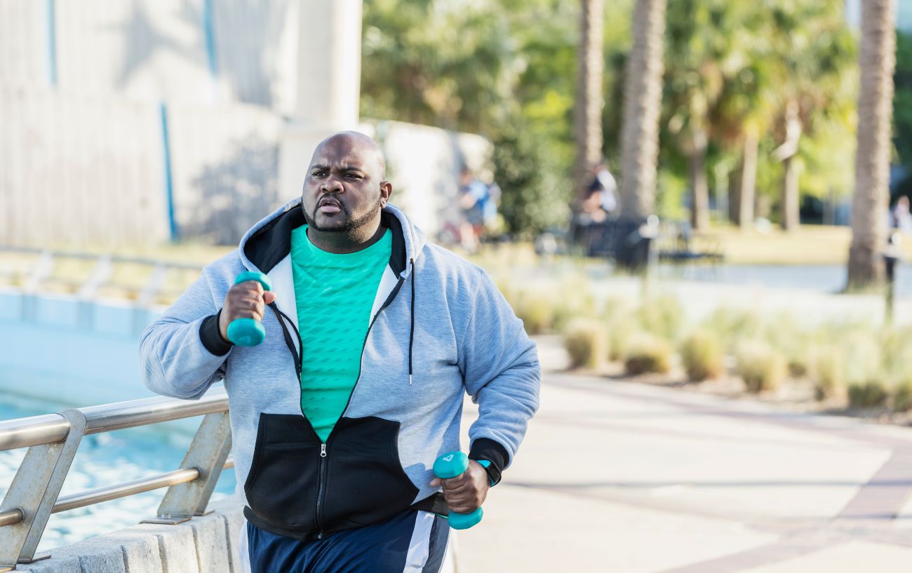 A person power walking with weights.