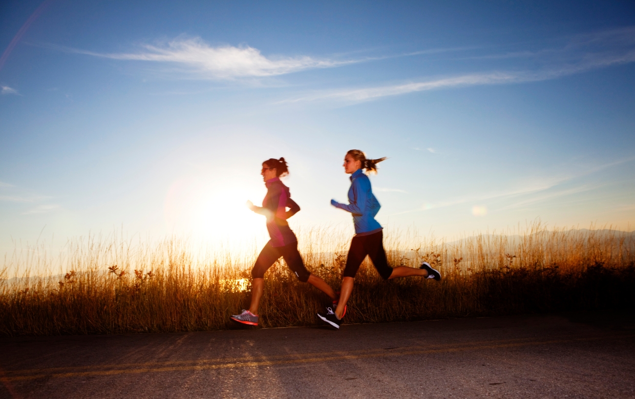 two runners running on the side of the road