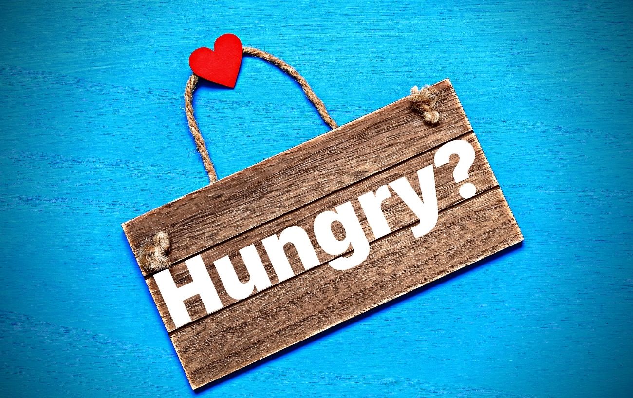 A wooden sign with the word hungry on it.